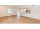 Bright living room featuring wood floors, white walls, and an open layout to the kitchen at 5607 N 76Th Pl, Scottsdale, AZ 85250