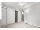 Bedroom features a ceiling fan, carpeted floors, and a large closet with shelving at 6514 S Lakeshore Dr # C, Tempe, AZ 85283