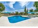 Inviting community pool with comfortable seating and shade under blue umbrellas at 6514 S Lakeshore Dr # C, Tempe, AZ 85283
