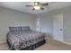 A gray-walled bedroom with a fan, bed, and two doors at 6520 S Pebble Beach Dr, Chandler, AZ 85249