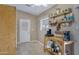 A cozy breakfast nook with a coffee station, open shelving, and a door to the backyard at 6520 S Pebble Beach Dr, Chandler, AZ 85249