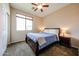 Comfortable bedroom features carpet, ceiling fan, neutral paint and natural light from a bright window at 6796 W Evergreen Ter, Peoria, AZ 85383