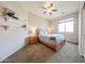 Inviting bedroom with neutral walls, carpeting, ceiling fan, and natural light from a large window at 6796 W Evergreen Ter, Peoria, AZ 85383