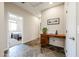 Hallway with a view into a bedroom and a built-in desk with drawers perfect for a home office at 6796 W Evergreen Ter, Peoria, AZ 85383