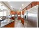 Spacious kitchen featuring stainless steel appliances, granite countertops, tile floor and plentiful dark wood cabinets at 6796 W Evergreen Ter, Peoria, AZ 85383