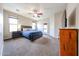 Spacious main bedroom with dark wood furniture, ceiling fan, and access to the exterior at 6796 W Evergreen Ter, Peoria, AZ 85383