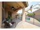 Covered patio with fan overlooking a fenced pool, blending indoor comfort with outdoor leisure at 6796 W Evergreen Ter, Peoria, AZ 85383