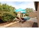 Backyard pool area featuring lounge chairs, umbrellas, and lush landscaping, perfect for relaxing at 6796 W Evergreen Ter, Peoria, AZ 85383