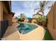 Private backyard pool area with lush landscaping, umbrellas and lounge chairs for ultimate relaxation at 6796 W Evergreen Ter, Peoria, AZ 85383