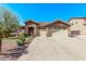 Inviting single-story home featuring a three-car garage, desert landscaping, and a tile roof at 694 E Heather Dr, San Tan Valley, AZ 85140