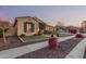 Beautifully landscaped front yard with lush green grass, walkway, and decorative plants enhancing the curb appeal at 7589 W Firebird Dr, Glendale, AZ 85308