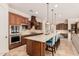 Beautiful kitchen with stainless steel appliances, granite countertops, and a large central island at 7589 W Firebird Dr, Glendale, AZ 85308