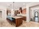 Spacious kitchen features stainless steel appliances, a large island with seating, and access to the entryway at 7589 W Firebird Dr, Glendale, AZ 85308
