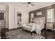 Tranquil main bedroom features a decorative rug, dark wood floors, and a bathroom en suite at 7589 W Firebird Dr, Glendale, AZ 85308
