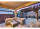 Inviting covered patio with ample seating, pergola, grill, and cozy atmosphere at 7844 W Molly Dr, Peoria, AZ 85383
