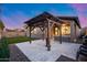 Inviting backyard with a pergola, paved patio, and lush green lawn perfect for outdoor entertaining at 7844 W Molly Dr, Peoria, AZ 85383