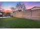 Private backyard features lush synthetic grass, block fence, and covered patio pergola perfect for entertaining at 7844 W Molly Dr, Peoria, AZ 85383
