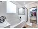 Modern bathroom featuring a soaking tub, glass-enclosed shower, and an adjacent walk-in closet at 7844 W Molly Dr, Peoria, AZ 85383