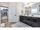 Elegant bathroom with double vanity, stylish mirrors, and access to the walk-in closet at 7844 W Molly Dr, Peoria, AZ 85383
