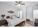 Bright bedroom featuring a ceiling fan, light wood floors and stylish wall decor at 7844 W Molly Dr, Peoria, AZ 85383
