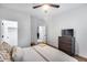 Light and airy bedroom with wood floors, a comfortable bed, and a dresser with a TV at 7844 W Molly Dr, Peoria, AZ 85383