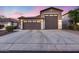 Charming exterior view of a well-maintained home with a three-car garage at dusk with ample parking space at 7844 W Molly Dr, Peoria, AZ 85383