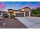 Inviting front yard showcasing a well-manicured landscape and attractive curb appeal, showcasing the garage at 7844 W Molly Dr, Peoria, AZ 85383
