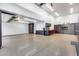 A spacious garage with built-in cabinets, work area, epoxy floors, and ample lighting at 7844 W Molly Dr, Peoria, AZ 85383