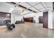 Spacious garage with epoxy floor, dark wood cabinets, ample storage, and motorcycle at 7844 W Molly Dr, Peoria, AZ 85383
