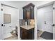 Dark wood bar with granite countertop between entryways to a half bathroom and hallway at 7844 W Molly Dr, Peoria, AZ 85383