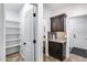 Hallway area with white shelving and a dark wood bar with a granite countertop at 7844 W Molly Dr, Peoria, AZ 85383