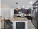 Well-equipped kitchen features stainless steel appliances, a granite-topped island, and stylish dark cabinetry at 7844 W Molly Dr, Peoria, AZ 85383