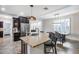 Kitchen island with bar seating, granite countertops, and stainless steel appliances, open to the dining area at 7844 W Molly Dr, Peoria, AZ 85383