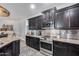 Well appointed kitchen with granite countertops, stainless steel appliances, and silver backsplash at 7844 W Molly Dr, Peoria, AZ 85383
