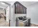 Laundry area featuring dark wood upper cabinets and stainless steel washer and dryer units at 7844 W Molly Dr, Peoria, AZ 85383