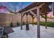Outdoor seating area with pergola, patio heater, grill, and low-maintenance landscaping at 7844 W Molly Dr, Peoria, AZ 85383