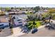 Aerial view of the house with mature landscaping, a well-kept lawn, and a long driveway for curb appeal at 8613 E Citrus Way, Scottsdale, AZ 85250