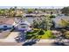 Charming home with lush front lawn, mature tree, and a long driveway showcasing great curb appeal from above at 8613 E Citrus Way, Scottsdale, AZ 85250