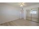 Inviting bedroom features light, wood-look floors, closet with mirrored sliding doors, and a bright window at 8613 E Citrus Way, Scottsdale, AZ 85250