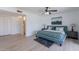 Well-lit bedroom with closet and bathroom access featuring a ceiling fan, artwork, and sleek flooring at 8613 E Citrus Way, Scottsdale, AZ 85250