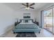 A naturally-lit bedroom with a ceiling fan opens to the backyard, creating a serene living space at 8613 E Citrus Way, Scottsdale, AZ 85250
