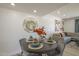 Dining room featuring stylish furniture, decorative mirror, and an open connection to the living area at 8613 E Citrus Way, Scottsdale, AZ 85250