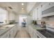 Well-lit kitchen with white cabinetry and modern appliances, complemented by a view into the dining area at 8613 E Citrus Way, Scottsdale, AZ 85250