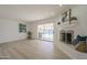 Bright living room featuring a fireplace and sliding door to a refreshing pool area, creating a cozy and inviting space at 8613 E Citrus Way, Scottsdale, AZ 85250