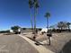 Charming single-story home with desert landscaping and palm trees against a clear blue sky at 9068 E Chambers St, Mesa, AZ 85208