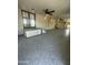 A spacious living room features neutral paint, ceiling fans, and an elevated space with French doors at 9068 E Chambers St, Mesa, AZ 85208
