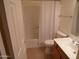 Bathroom features tile floors, a vanity, and a shower-tub combo behind a curtain at 10302 E Cicero Cir, Mesa, AZ 85207