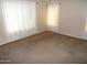 A simple bedroom design with carpeted flooring and natural light coming through the window at 10302 E Cicero Cir, Mesa, AZ 85207