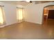 An empty living room features tile flooring, neutral walls, and natural light through a window at 10302 E Cicero Cir, Mesa, AZ 85207