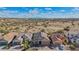 An aerial view shows the roof, neighborhood and surrounding desert area at 10841 W Nosean Rd, Peoria, AZ 85383